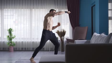 Young-man-shadowboxing-at-home-to-maintain-his-fitness-and-fitness
